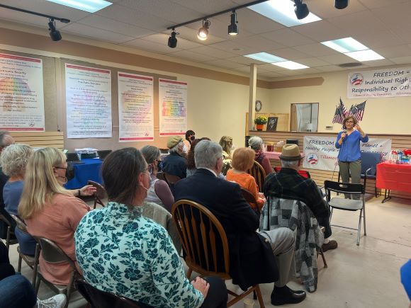 Suzanne talking with a group